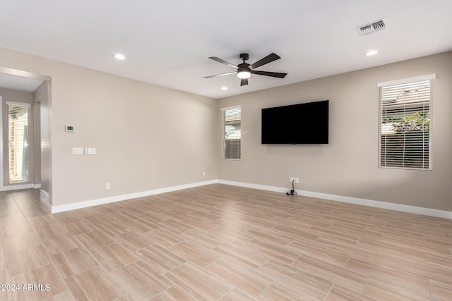 unfurnished living room with plenty of natural light and ceiling fan