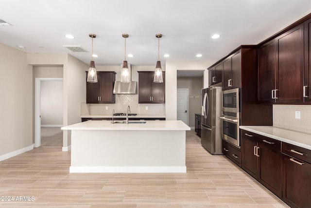 kitchen with dark brown cabinetry, stainless steel appliances, sink, a center island with sink, and hanging light fixtures