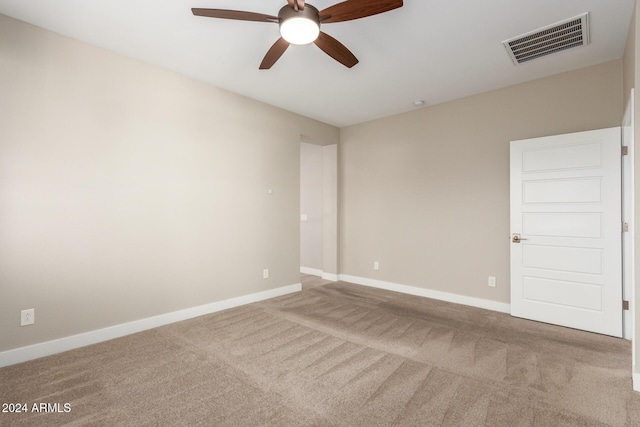 empty room with ceiling fan and carpet