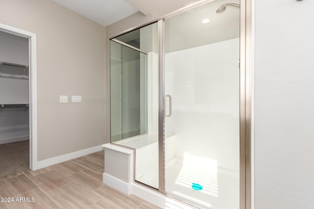 bathroom with a shower with door