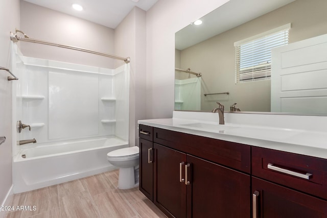 full bathroom featuring wood-type flooring, vanity, toilet, and shower / washtub combination