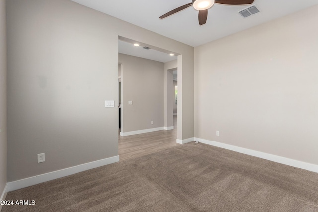 carpeted empty room featuring ceiling fan