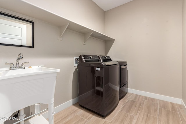 washroom with washer and dryer and sink