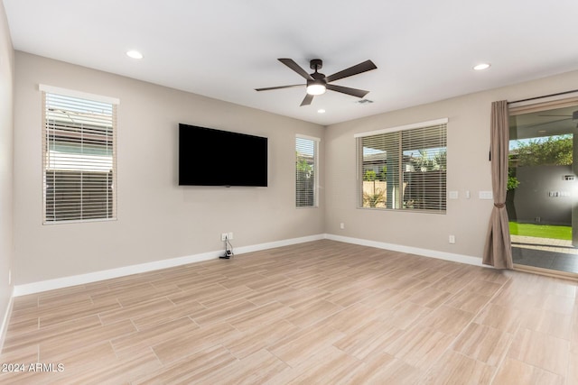 unfurnished living room featuring ceiling fan and light hardwood / wood-style floors