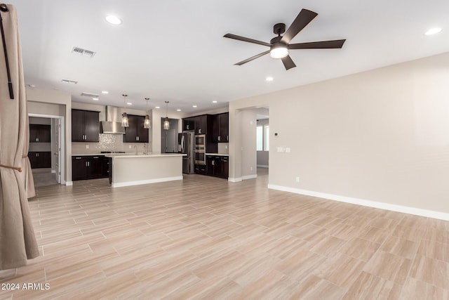 unfurnished living room with light hardwood / wood-style flooring and ceiling fan