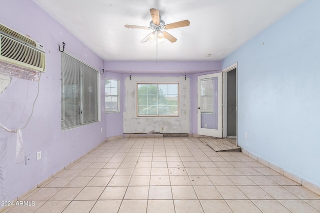 unfurnished room featuring light tile patterned flooring, ceiling fan, and a wall unit AC