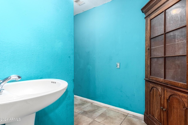 bathroom with tile patterned flooring and sink