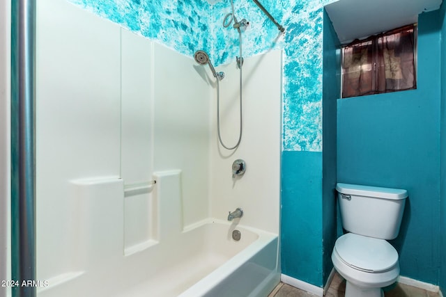 bathroom featuring toilet and bathing tub / shower combination