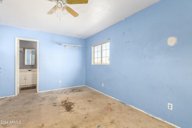 unfurnished bedroom featuring ceiling fan, ensuite bathroom, sink, and carpet floors