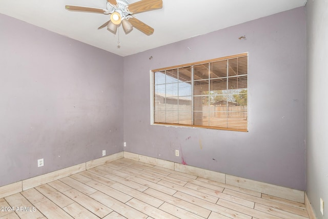 empty room with light hardwood / wood-style flooring and ceiling fan