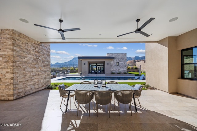 view of patio featuring a mountain view and ceiling fan