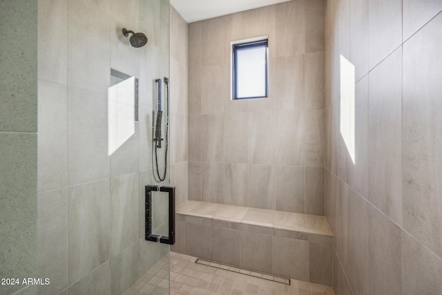 bathroom with a shower with door