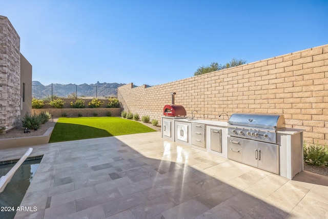 view of patio featuring a mountain view and area for grilling