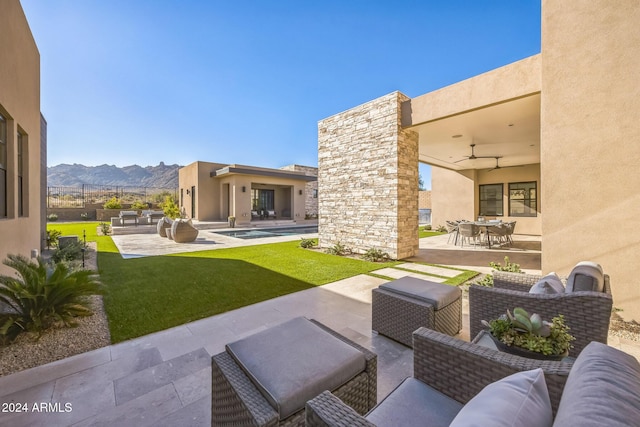 view of patio / terrace with a mountain view, a pool, and an outdoor hangout area