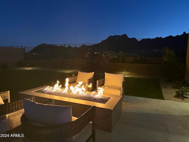 patio at night featuring a fire pit