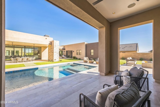 view of swimming pool featuring an in ground hot tub and a patio