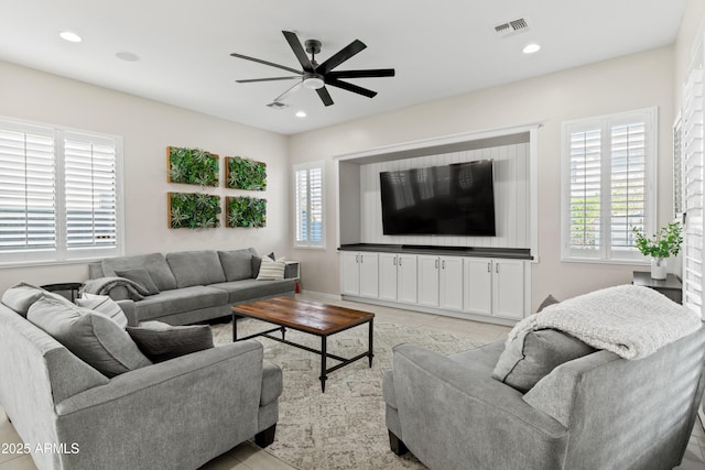 living area featuring a ceiling fan, recessed lighting, and visible vents