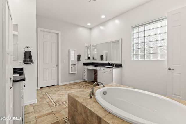 full bath with recessed lighting, visible vents, vanity, baseboards, and a bath