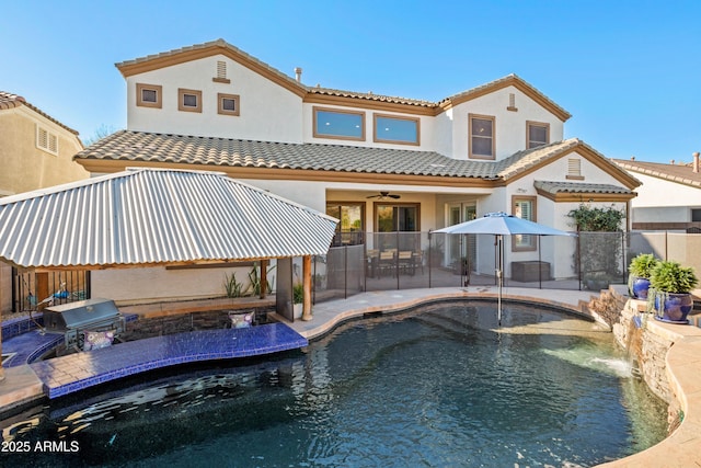 back of property with a patio area, area for grilling, fence, and stucco siding