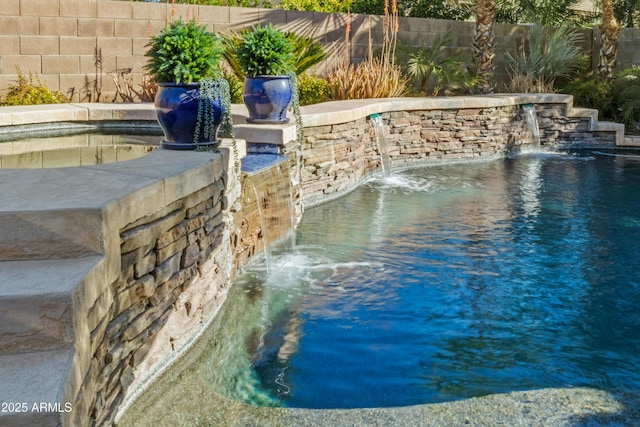 view of pool with a fenced backyard, an outdoor hot tub, and a fenced in pool