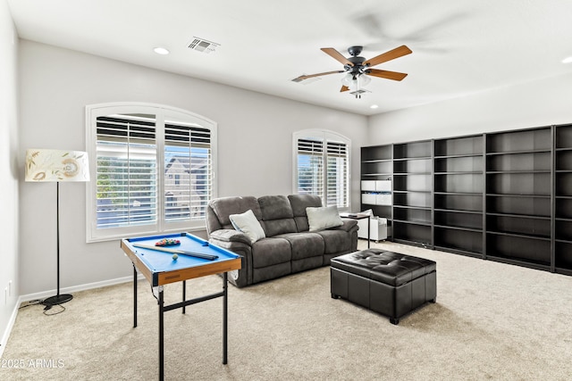 carpeted living area featuring baseboards, visible vents, a ceiling fan, and recessed lighting