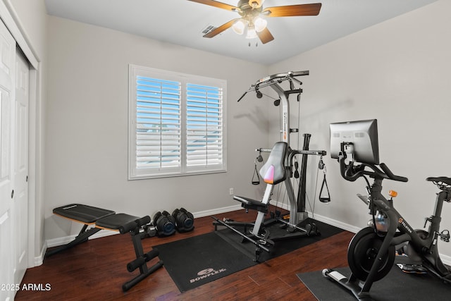 workout area featuring baseboards, visible vents, ceiling fan, and wood finished floors