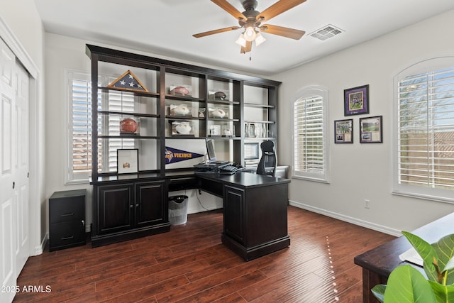 office area with baseboards, dark wood-type flooring, visible vents, and a ceiling fan