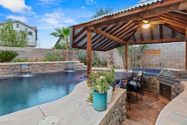 view of swimming pool featuring a fenced backyard, area for grilling, a gazebo, exterior kitchen, and a patio area