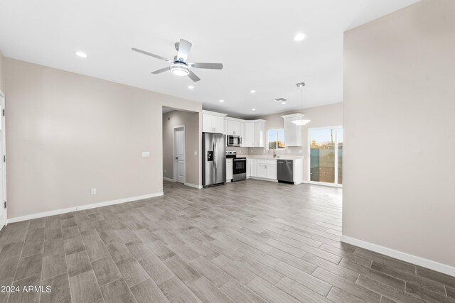 kitchen featuring sink, white cabinets, and stainless steel appliances