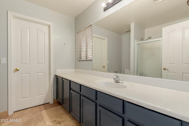 bathroom featuring vanity, toilet, and walk in shower