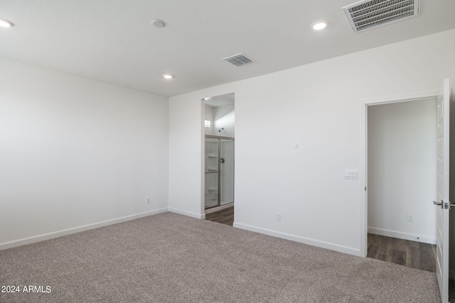 empty room with dark colored carpet