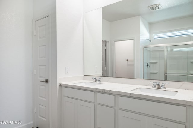 bathroom featuring vanity and an enclosed shower