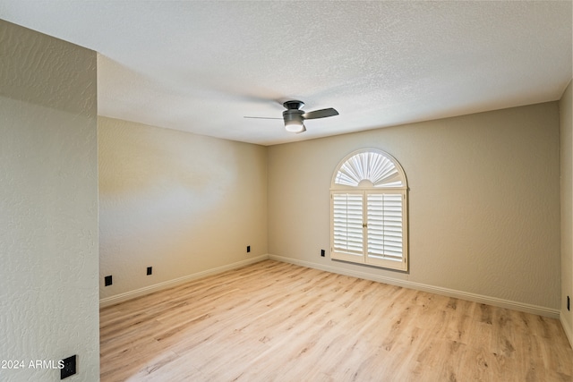 empty room featuring a textured ceiling, ceiling fan, and light hardwood / wood-style flooring