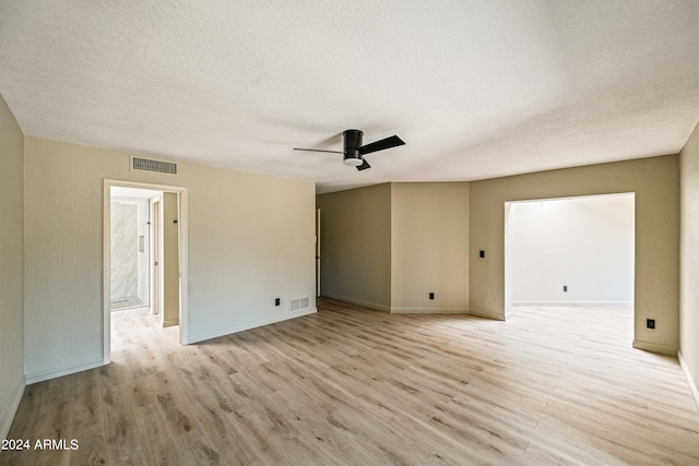 unfurnished room with ceiling fan, a textured ceiling, and light wood-type flooring