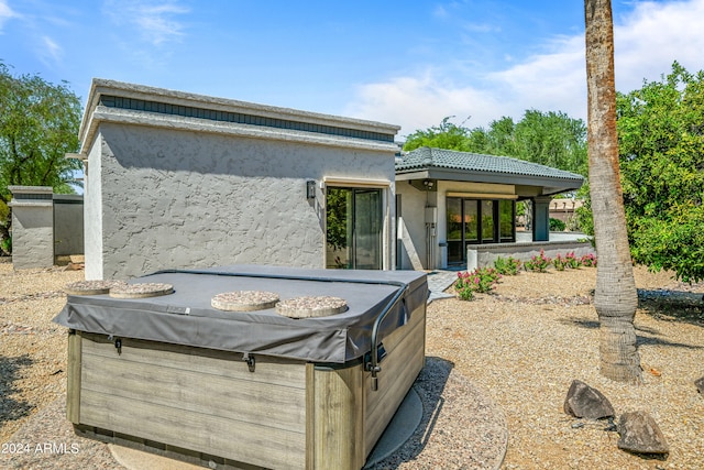 exterior space with a hot tub