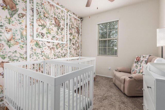 bedroom featuring baseboards, carpet floors, a nursery area, and ceiling fan