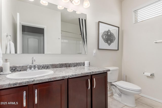 bathroom featuring toilet, vanity, and tile patterned flooring