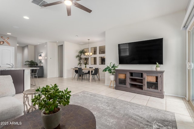 living room featuring a ceiling fan, light tile patterned floors, recessed lighting, and visible vents