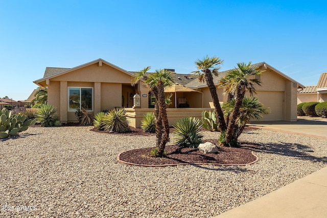 view of front of house with a garage, driveway, and stucco siding