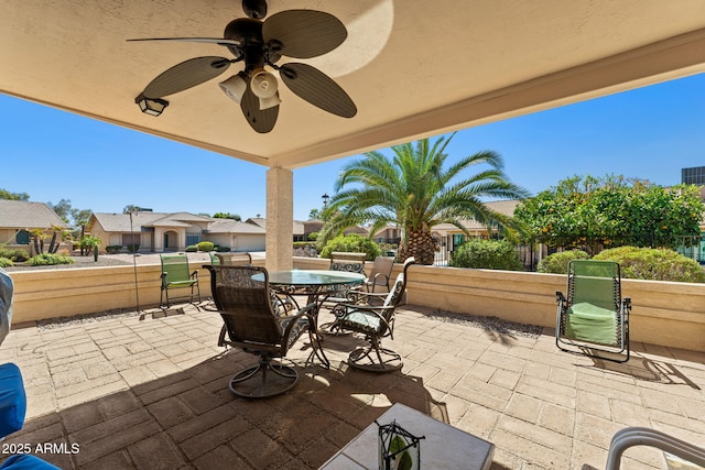 view of patio / terrace featuring outdoor dining space, fence, and a ceiling fan