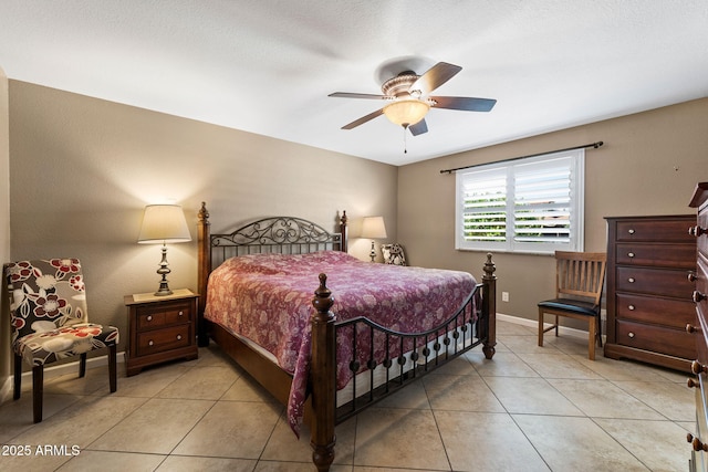 bedroom with light tile patterned floors, ceiling fan, and baseboards