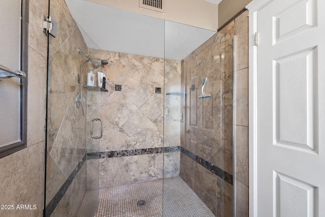 bathroom featuring a stall shower and visible vents