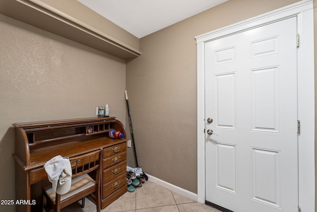 office space with light tile patterned floors and baseboards