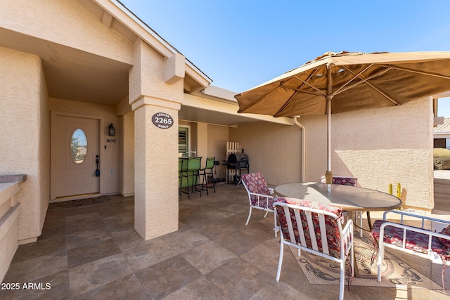 view of patio with outdoor dining area and a grill