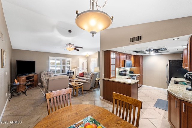 dining room featuring light tile patterned floors, visible vents, and a ceiling fan