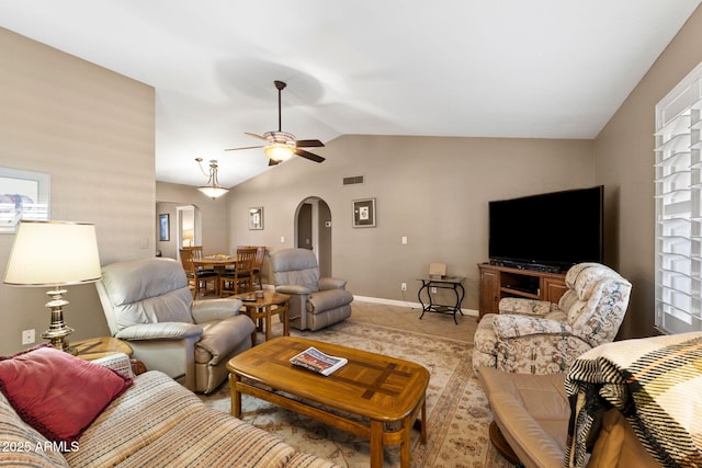 living area with arched walkways, ceiling fan, light tile patterned floors, visible vents, and vaulted ceiling