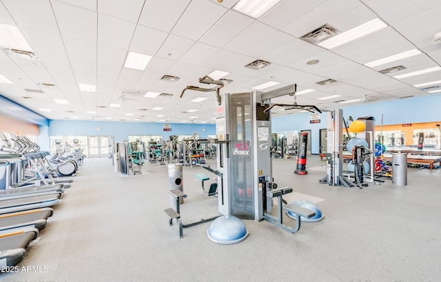 exercise room featuring a paneled ceiling and visible vents