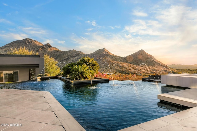 exterior space featuring a floating dock and a mountain view