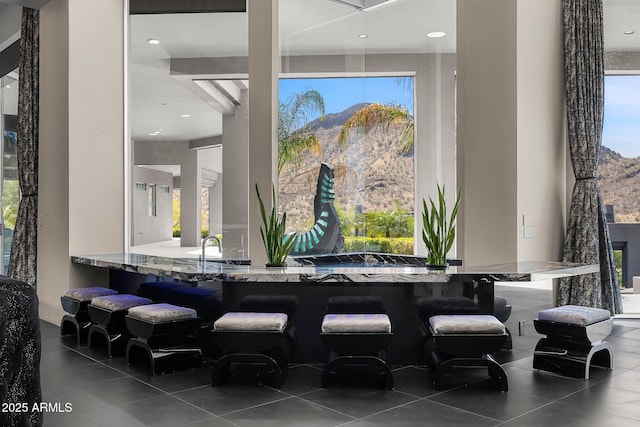 bar featuring a mountain view and tile patterned floors