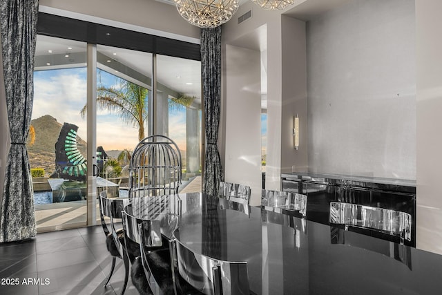 dining area featuring a chandelier, tile patterned flooring, and visible vents